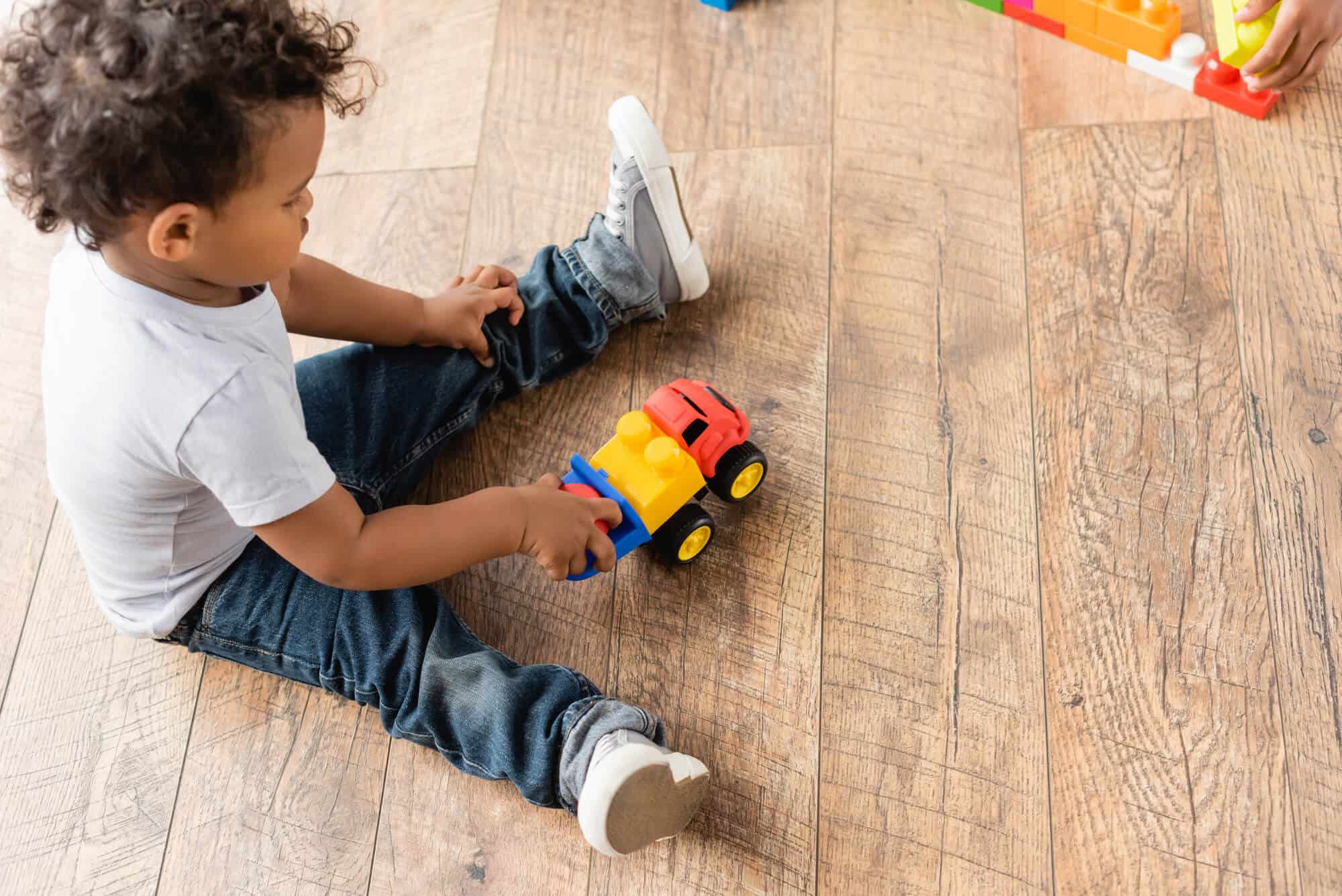 toddler playing with truck