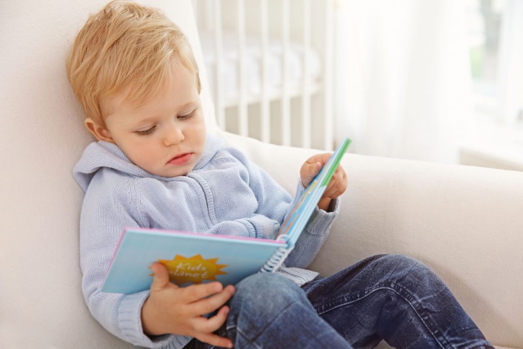 toddler with book