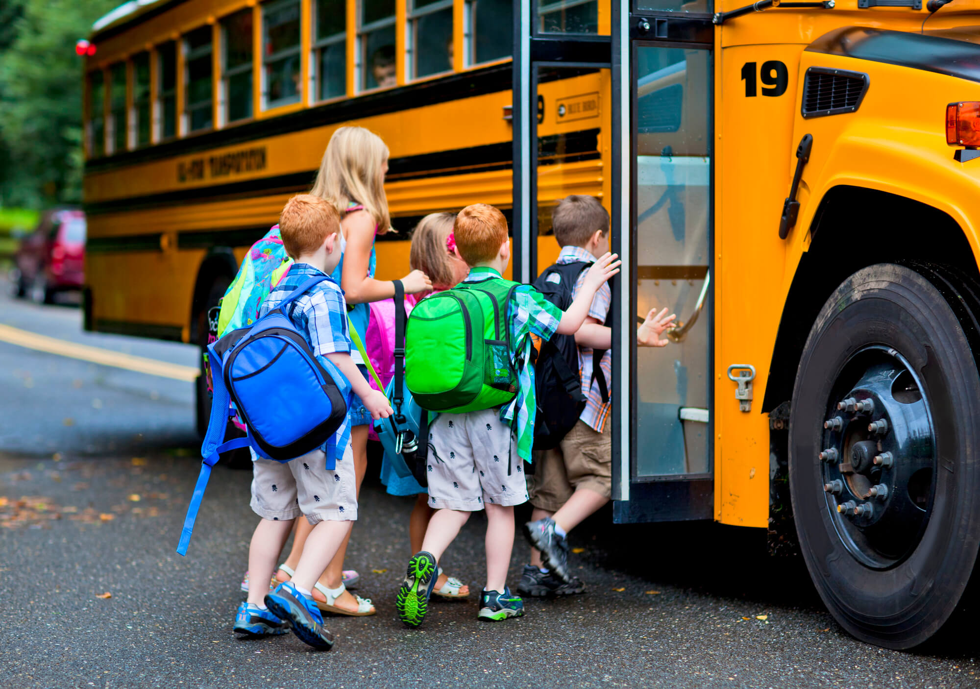 kids getting on a school bus