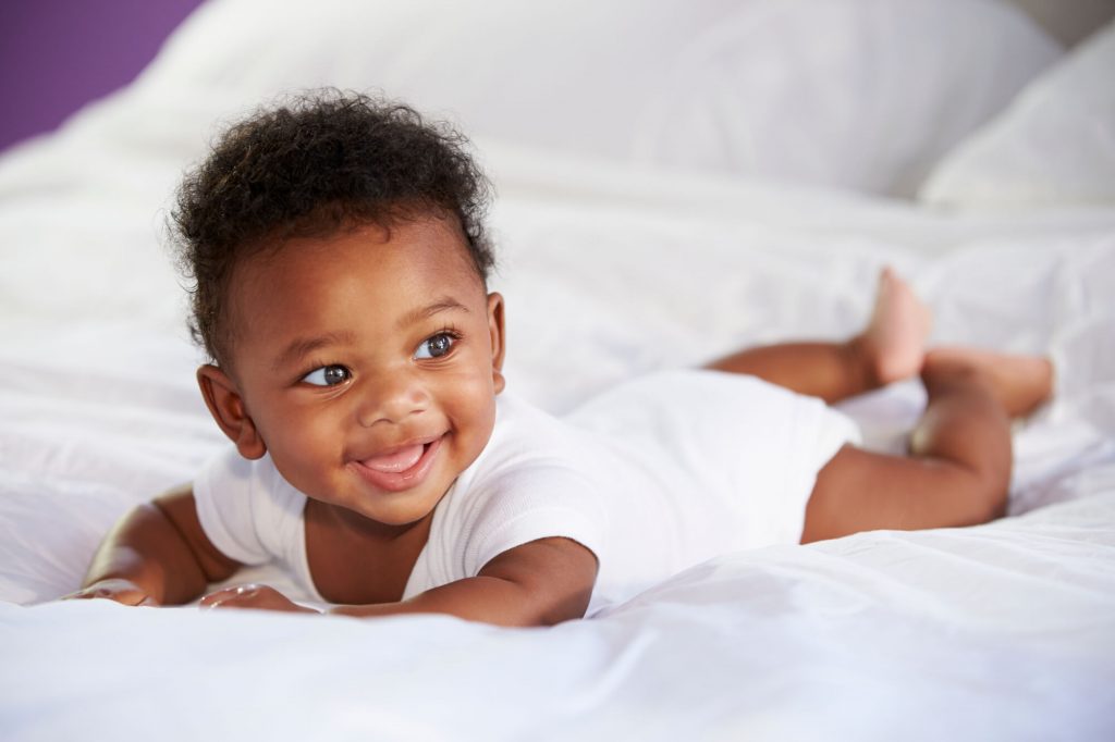 baby on its belly showing overlooked developmental milestones