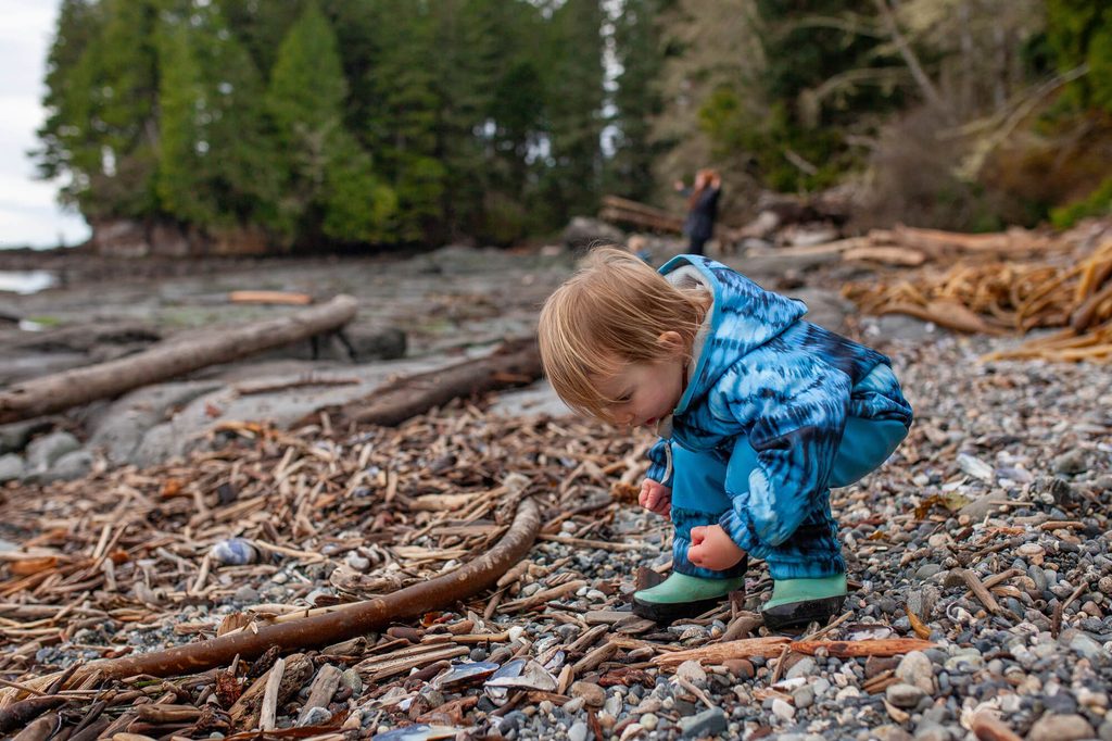 a toddler exploring rocks to show unstructured play