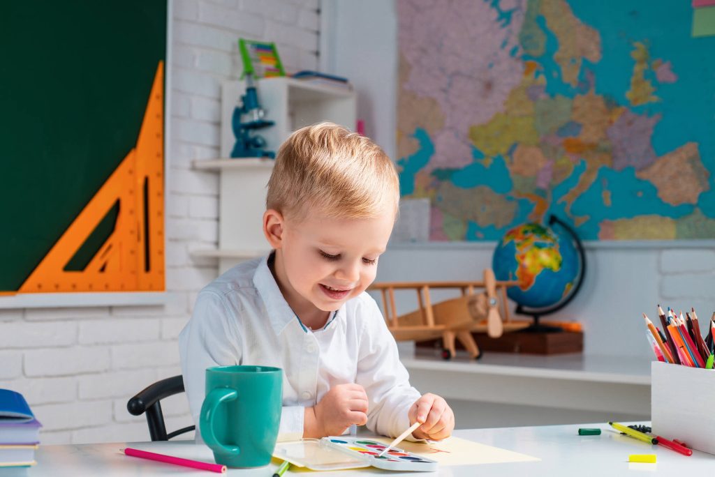 toddler boy learning and painting