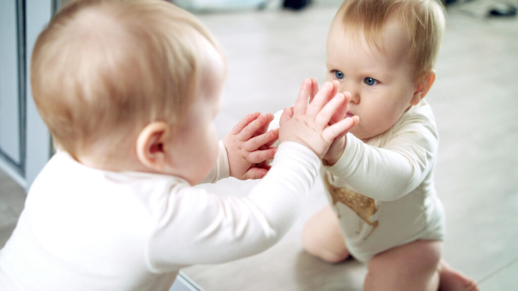 baby looking at reflection during mirror self-recognition test