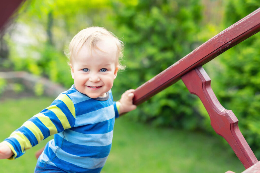 toddler on backyard playground