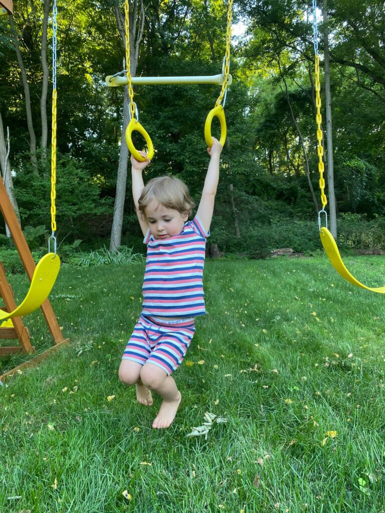 child on backyard playground