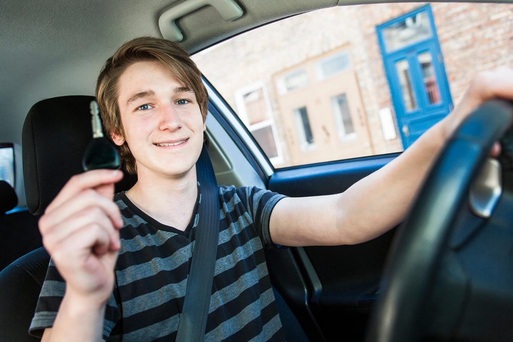 teen showing car keys to illustrate teen driving safety tips
