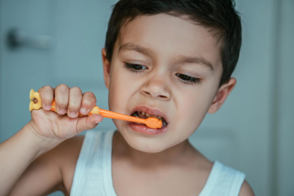 toddler brushing teeth to show healthy habits in children
