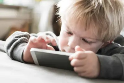 toddler playing on a device