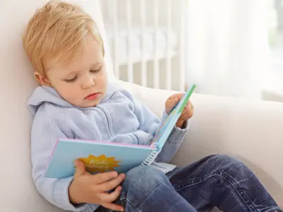 toddler with book