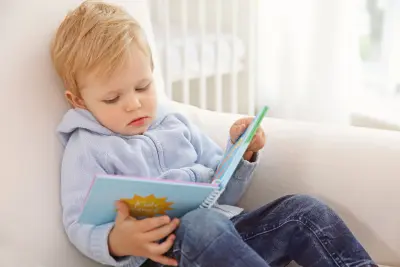 parent reading to child toddler with book