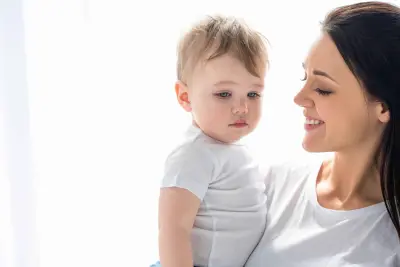 mom holding toddler mom holding toddler