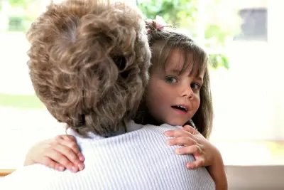 child hugging grandma holiday parenting tips