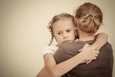 a mom hugging a girl to offer support