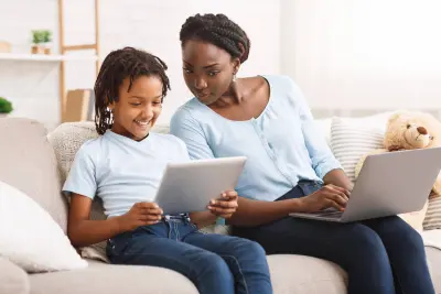 parent and child looking at computer parent and child looking at computer